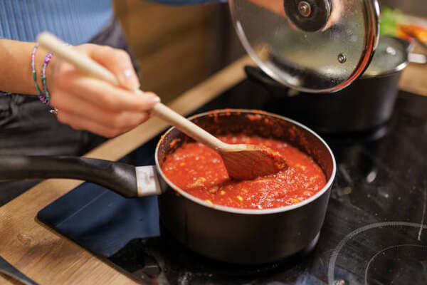 Easy Low-Carb Spaghetti Sauce Recipe for Keto Lovers 7 Making tomato pasta sauce while stirring