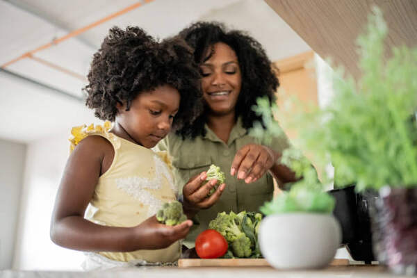 Keto for Picky Eaters: Family-Friendly Meal Ideas 14 Mother and daughter preparing vegetables for cooking