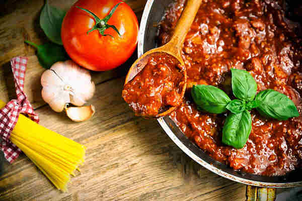 Easy Low-Carb Spaghetti Sauce Recipe for Keto Lovers 8 Spaghetti bolognese sauce with uncooked pasta, garlic, and tomato