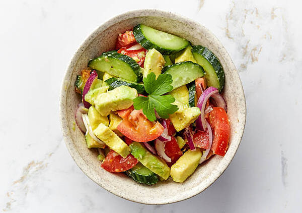 10 Low-Carb BBQ Sides Perfect for Your Next Grill Party 6 A bowl of avocado and cucumber salad with tomato and onion