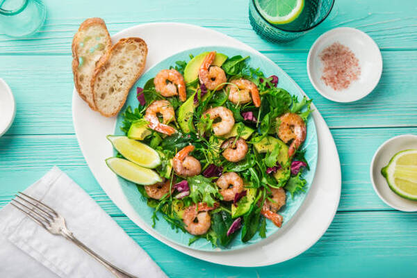 5 Irresistible Shrimp Keto Recipes for Low-Carb Dinners 9 Fresh healthy avocado and shrimps salad on a plate with toast