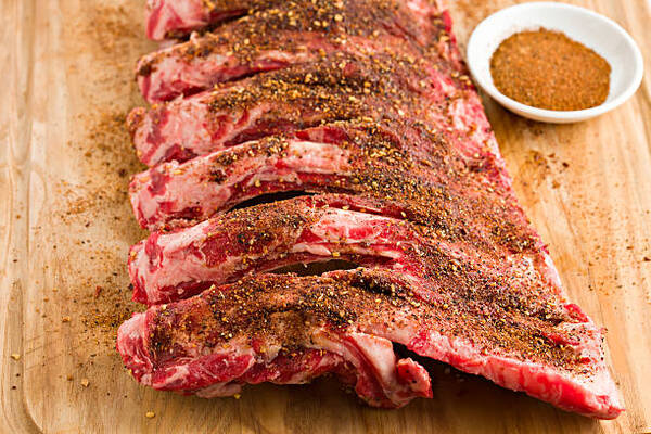 Best Rub for Ribs That Brings Big BBQ Flavor Fast 7 Beef ribs with spicy dry rub on a wooden board