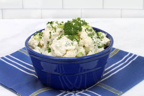 10 Low-Carb BBQ Sides Perfect for Your Next Grill Party 4 A bowl of cauliflower salad topped with parsley and green onion