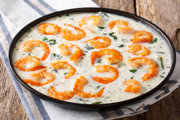 5 Irresistible Shrimp Keto Recipes for Low-Carb Dinners 5 Shrimp with spinach and spices in creamy Tuscan sauce close-up on a plate on a table