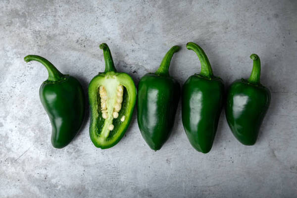 Easy Keto Jalapeno Poppers Recipe for a Spicy Snack 4 Green mexican jalapeno hot peppers on a baking sheet