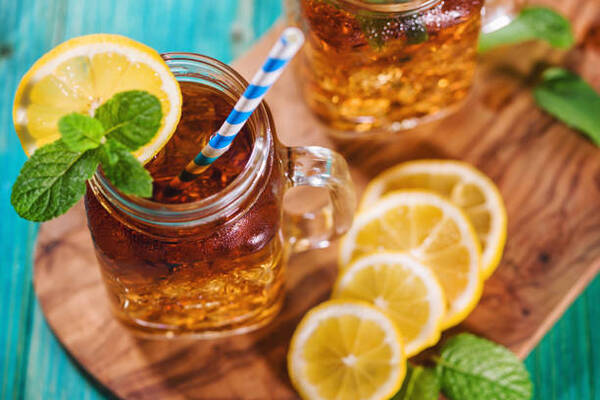 Understanding Iced Tea vs Sweet Tea: Key Differences 9 Freshly made iced tea with lemon and mint in a jar