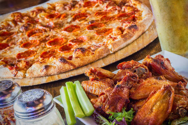 Easy Buffalo Chicken Pizza Recipe for Game Day Fun! 3 Pepperoni pizza with buffalo chicken wings and a pint of beer