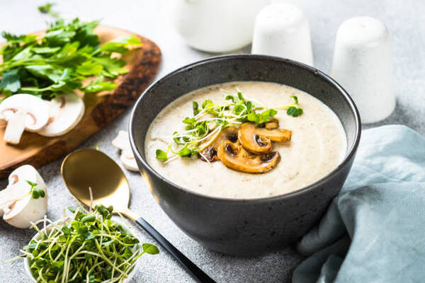 Easy Keto Mushroom Soup That’s Rich, Filling, and Low-Carb 2 Homemade mushroom soup with toppings in a bowl