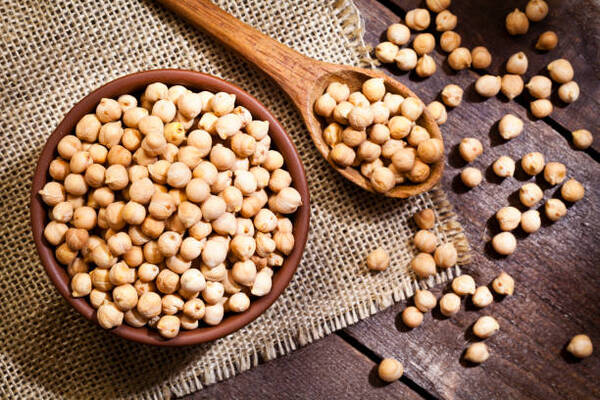 Is Chickpea Flour Keto? What You Need to Know 3 A wooden bowl and spoon filled with chickpeas