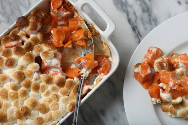 Delicious Keto Sweet Potato Casserole for Holiday Feasts 8 Traditional Thanksgiving sweet potato casserole dish and a serving of the potatoes on a plate