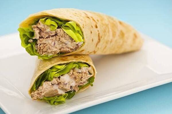 Best Keto Wraps to Buy or Make at Home Today 8 Two tuna melt wrap on a white plate on a blue background