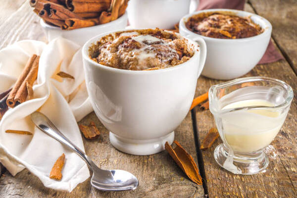Easy Keto Cinnamon Roll Mug Cake Ready in Minutes 2 Cinnamon cake in mug with sugar and cream cheese topping
