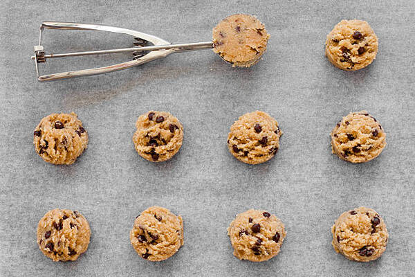 Keto No-Bake Cookies: 5 Variations for Every Craving 9 Almond meal chocolate chip uncooked cookie dough on a tray with ice cream scoop