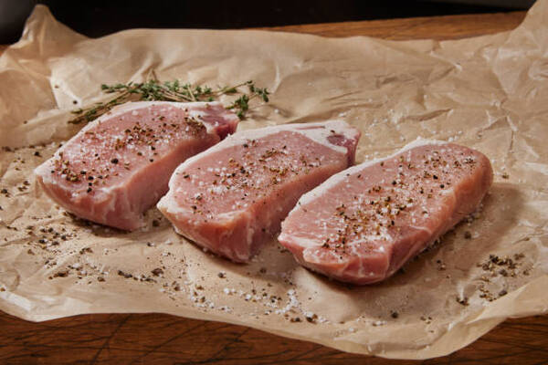 Easy 4-Ingredient Oven-Baked Pork Chops for Busy Nights 4 Seasoning raw boneless pork loin chops with salt and pepper