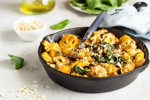 Cauliflower Bake: Deliciously Cheesy and Healthy Recipe 4 3 roasted cauliflower with spinach raisin nuts cast iron pan min 1