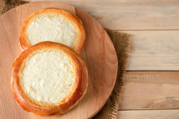 Keto English Muffin Recipe for Quick Breakfasts 9 Two freshly baked English muffins are placed on a wooden board