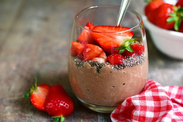 Delicious Low-Carb Chia Pudding Recipe Perfect for Any Day 5 Chocolate chia seed pudding with strawberry in a glass on a rustic wooden table