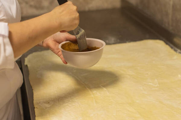 Easy Keto Cinnamon Buns Recipe for Sweet Indulgence 7 Sprinkling the cinnamon roll dough with butter and filling