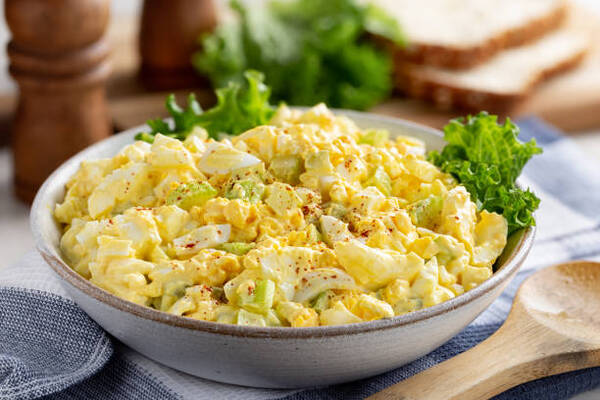 Easy Egg Salad Lettuce Wrap Recipe for a Quick Lunch 3 Egg salad in a bowl with bread slices and lettuce leaves