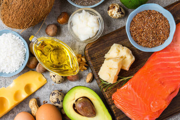 Clean Eating Food List You Need for Everyday Healthy Meals 9 Selection of good fat and omega 3 sources including avocado, nuts, dairy, and fish