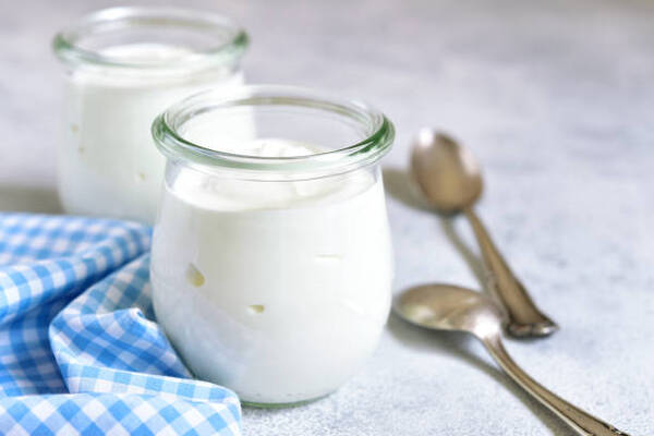 Easy Keto Yogurt Recipe for Breakfast, Desserts, and Snacks 2 Two portions of fresh natural homemade yogurt in a glass jar