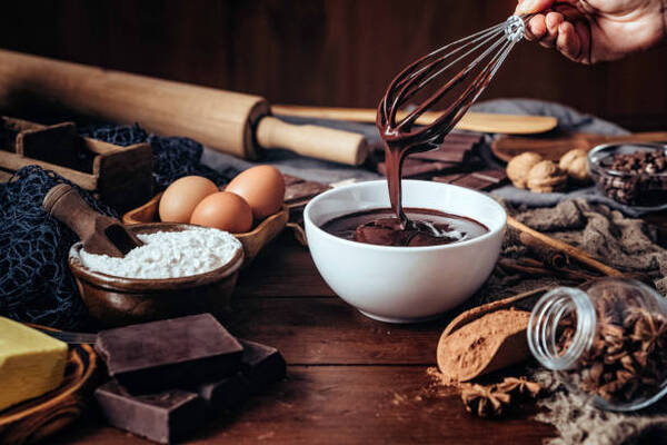 Easy Keto Chocolate Mousse Recipe for a Quick Dessert Fix 4 Making chocolate mousse on a wooden table in a rustic kitchen