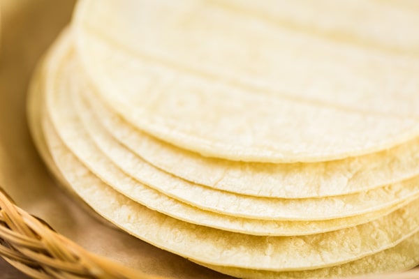 Are Corn Tortillas Keto or Just a Carb Trap? 4 A close-up view of a stack of corn tortillas in a woven basket