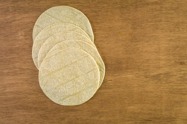 Are Corn Tortillas Keto or Just a Carb Trap? 7 A stack of corn tortillas laid out on a wooden surface