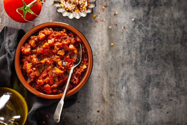 Keto Turkey Chili With Big Flavor Boost 6 A rustic bowl of keto turkey chili with a rich tomato base and chunky vegetables, served with a spoon