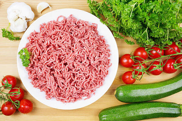 Hearty Hamburger Zucchini Casserole for the Whole Family 4 Plate with fresh raw minced meat, zucchini, tomatoes, garlic, and parsley