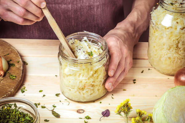 Is Sauerkraut Keto or Not? What You Need to Know 6 Making sauerkraut with cabbage and spices in a jar
