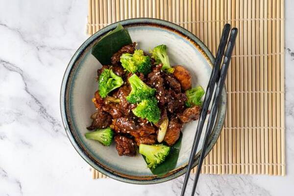 Easy Mongolian Beef Recipe You Can Make at Home Tonight 8 An overhead view of a delicious meal of Mongolian beef and broccoli served in a bowl