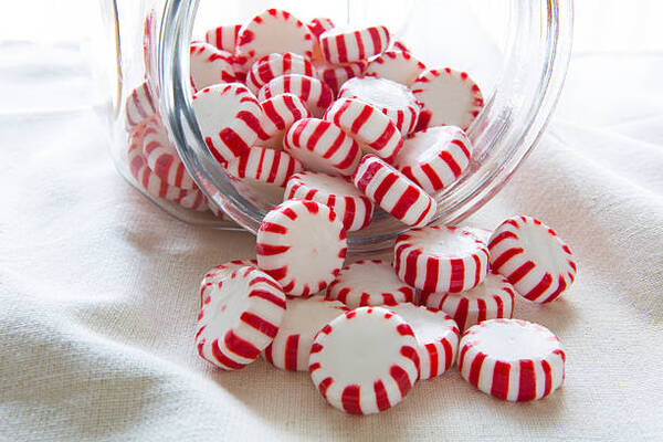 10 Delicious Keto-Friendly Candy Options to Buy or Make 9 Peppermint candies spilling out of a jar
