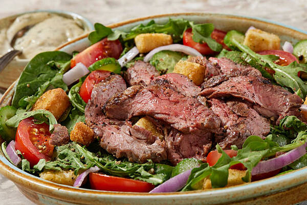 Keto Subway Protein Bowl Choices That Fit Your Low-Carb Diet 5 Grilled steak salad bowl with tomatoes, red onions, and mixed greens