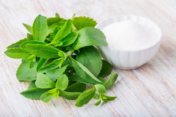 Is Coconut Sugar Keto or Just Another Sweetener Trap? 10 Stevia leaves with a bowl of granulated stevia