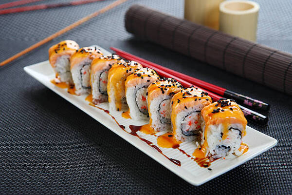 Spicy mayo on baked salmon California roll